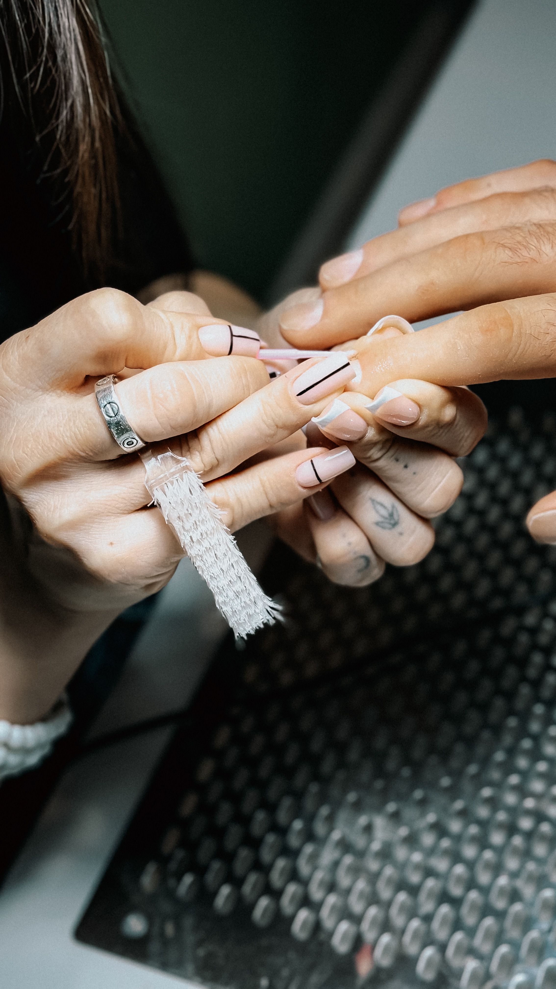 Nail technician applying polish during a manicure