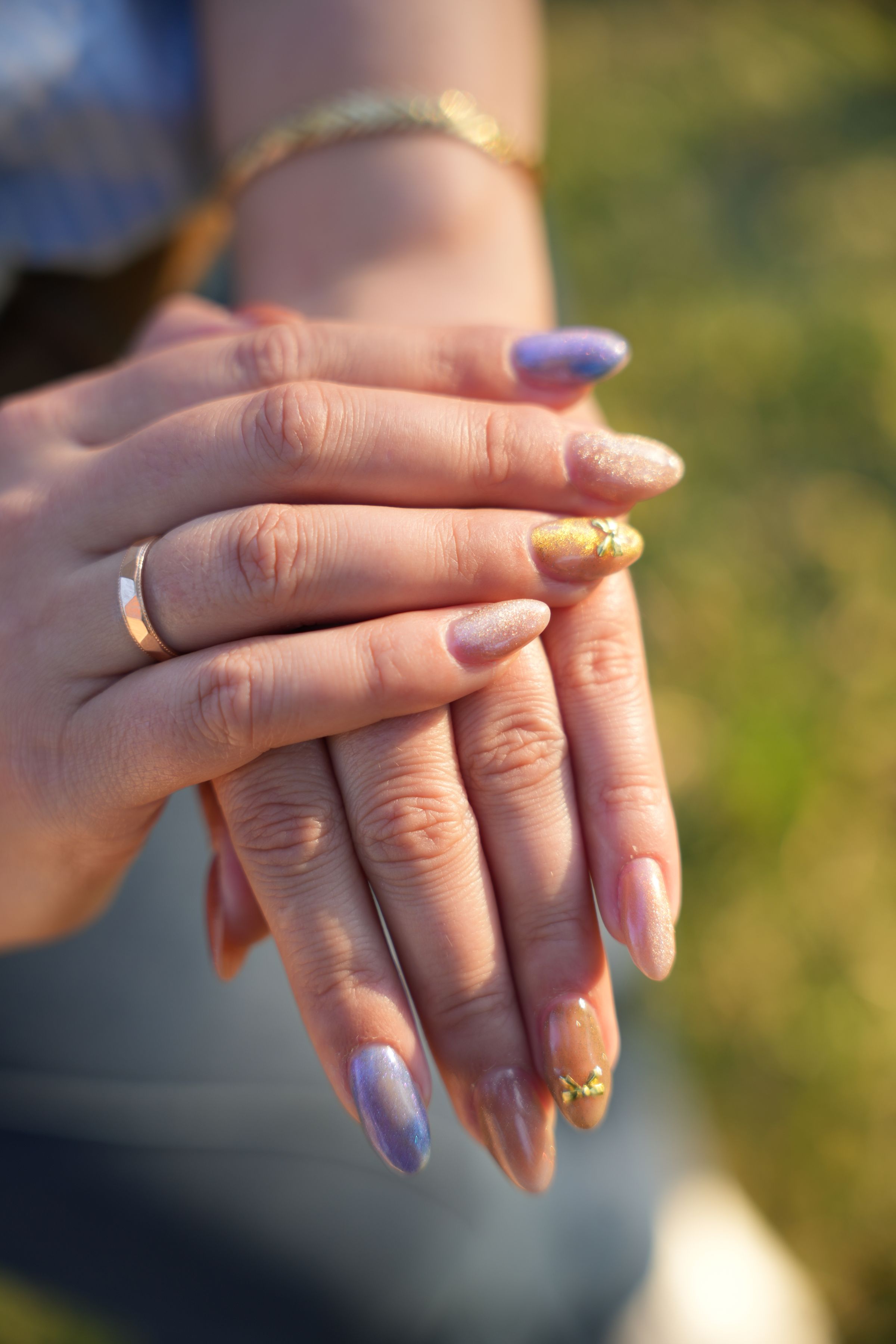 Shimmering neutral manicure with blue and gold accents
