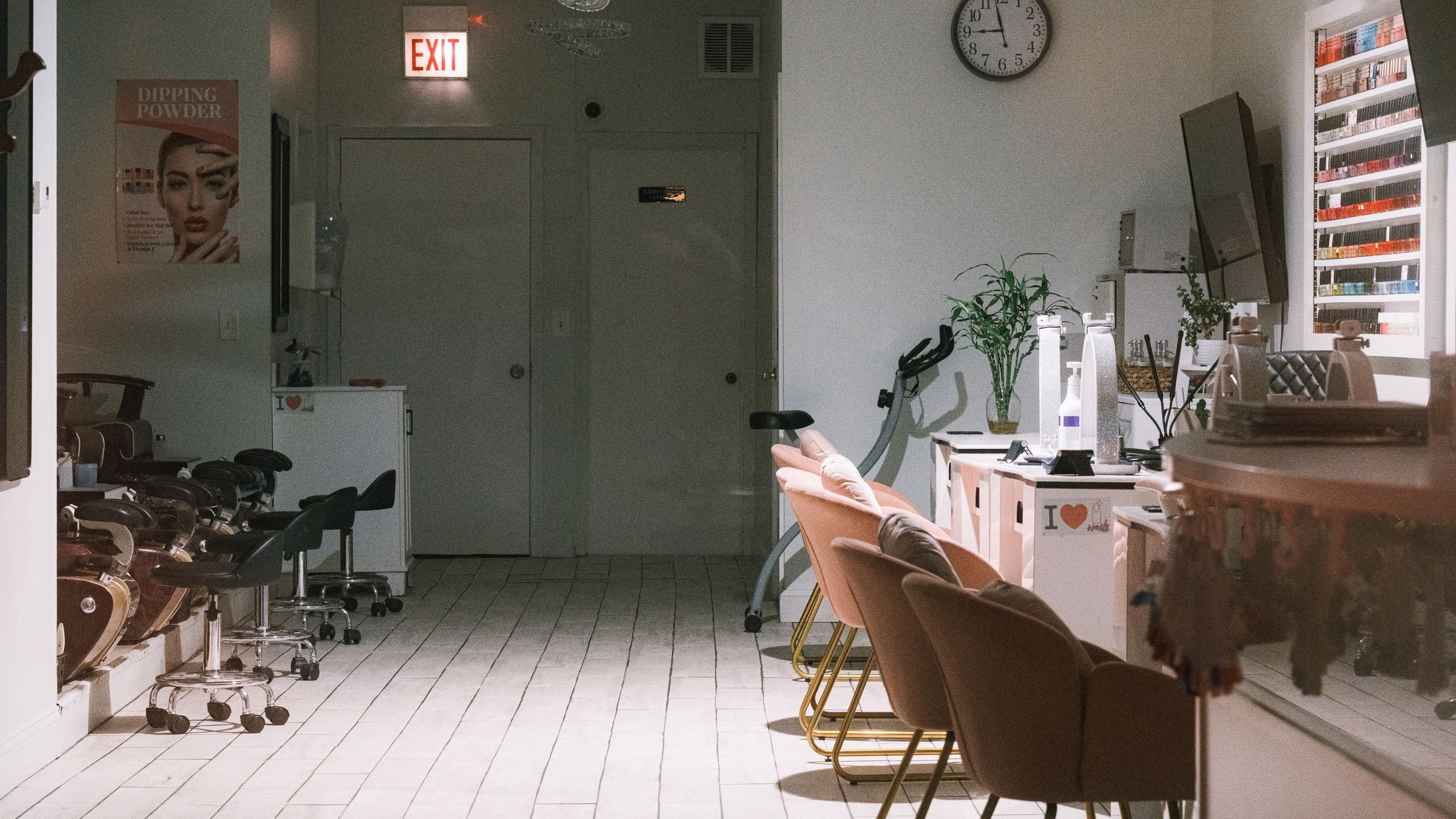 Modern nail studio with manicure tables and polish displays